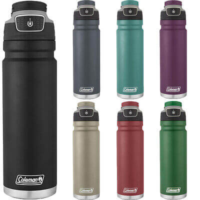Stainless steel Coleman FreeFlow bottle on a wooden table with water droplets and eco-friendly tag.
