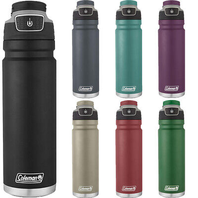 Stainless steel Coleman FreeFlow bottle on a wooden table with water droplets and eco-friendly tag.